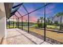 Enjoy the spacious screened-in patio with views of the lake and surrounding greenery at 281 Potenza Loop, Nokomis, FL 34275