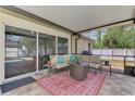 Covered patio with comfortable seating and stylish rug with a view of the backyard and pool at 3021 Toluca Ter, North Port, FL 34286
