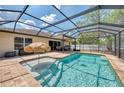 A beautiful private screened-in pool with patio and a sun umbrella for shade and relaxation at 3021 Toluca Ter, North Port, FL 34286