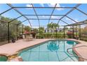 Inviting screened-in pool area with a patio, landscaping, and outdoor seating for relaxation at 3301 Santa Barbara Dr, Punta Gorda, FL 33983