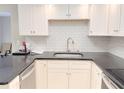 Clean kitchen showcases granite countertops, white cabinets, and modern fixtures at 4158 Tamiami Trl # A5, Port Charlotte, FL 33952