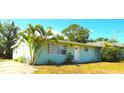 Inviting single-story home with a mature palm tree, green grass, and a freshly painted exterior at 514 Showalter Ave, Punta Gorda, FL 33950