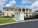 Exterior showcases a condo with covered parking, storage units, and manicured landscaping at 5800 Sabal Trace Dr # 1201, North Port, FL 34287