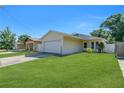 Charming single-story home with a well-maintained lawn and a two-car garage at 6841 46Th N St, Pinellas Park, FL 33781