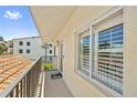 Balcony view showcasing a tranquil neighborhood and the building's architectural details including tiled roof at 876 Golden Beach Blvd # 876, Venice, FL 34285