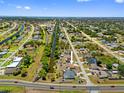 A captivating aerial view showcases this lovely home with a pool in a lush, green neighborhood at 10517 Greenway Ave, Englewood, FL 34224
