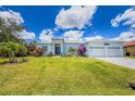 Well-manicured lawn and landscaping enhance the curb appeal of this home with a 3-car garage at 13284 Amaryllis Cir, Port Charlotte, FL 33981
