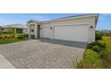 A well-designed driveway leads to a home with a two-car garage, framed by manicured landscaping at 16440 Marsh Ln, Punta Gorda, FL 33982