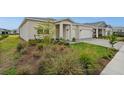A cozy home featuring a manicured lawn and beautiful landscaping, creating a welcoming outdoor space at 16440 Marsh Ln, Punta Gorda, FL 33982