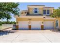 Three car garage and address of the home with lush green trees surrounding the building at 16572 San Edmundo Rd # 111, Punta Gorda, FL 33955