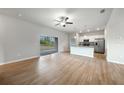 Bright, open living room with sliding glass doors, leading to an open kitchen with stainless steel appliances at 18503 Ellen Ave, Port Charlotte, FL 33948