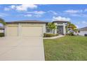 Charming single-Gathering home with a three car garage, lush lawn, and well manicured landscaping at 19246 Moore Haven Ct, Port Charlotte, FL 33948
