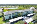 Attractive three-story condo building with covered parking and tropical landscaping in a waterfront community at 2160 Heron Lake Dr # 201, Punta Gorda, FL 33983