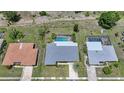 Aerial view of home showcasing the screened pool, backyard, mature landscaping, and neighboring properties at 2193 Beacon Dr, Port Charlotte, FL 33952