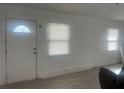 Bright living room with neutral paint, new flooring, updated door and window at 230 Waterway Cir Ne, Port Charlotte, FL 33952