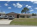Single-story home with a well-manicured lawn and attached garage, ample driveway parking at 23269 Lehigh Ave, Port Charlotte, FL 33954
