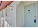 Close-up of a condo front door with the unit number and entryway architectural details at 25100 Sandhill Blvd # F-203, Punta Gorda, FL 33983