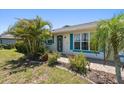 Inviting front entrance with decorative security door, complemented by colorful landscaping and charming details at 25449 Doredo Dr, Punta Gorda, FL 33955