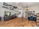 Open-concept living room features stylish wood floors, a coffered ceiling, and an open view to the kitchen at 2707 Auburn Blvd, Port Charlotte, FL 33948