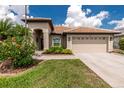 Charming single-story home featuring a tile roof, two-car garage and well-maintained landscaping at 2913 Royal Palm Dr, North Port, FL 34288