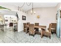 Dining area featuring tile floors, a chandelier, and a rustic table with seating for six at 3058 Curry Ter, Port Charlotte, FL 33981