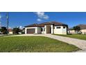 Charming single-story home with well-manicured lawn and brick paver driveway at 432 Gun Cay Ln, Punta Gorda, FL 33950