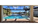 Beautiful screened-in pool and spa overlooking a serene canal with dock and boat lift at 432 Gun Cay Ln, Punta Gorda, FL 33950