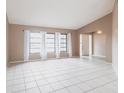 Spacious living room with tile floors, neutral walls, and bright natural lighting at 4788 Abadan St, North Port, FL 34287