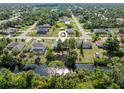 Serene aerial view showcasing a home with water access, lush greenery, and peaceful neighborhood surroundings at 485 Dorchester St, Port Charlotte, FL 33954