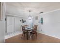 Inviting dining area features neutral walls, wood floors, and an elegant chandelier fixture at 6070 80Th N St # 215, St Petersburg, FL 33709