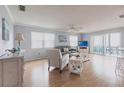 Bright living room with wood floors, neutral decor, and sliding glass doors to a private balcony at 6070 80Th N St # 215, St Petersburg, FL 33709