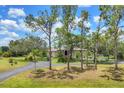 Sprawling home set back from the road, with a long driveway and mature trees at 6242 Tropicaire Blvd, North Port, FL 34291