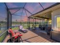 Relaxing screened patio with comfortable seating, string lights and views of the pond at 6242 Tropicaire Blvd, North Port, FL 34291