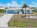 Charming single-story home with a well-maintained front yard and a two-car garage at 732 Santa Margerita Ln, Punta Gorda, FL 33950