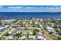 Aerial view of a charming community near a stunning bay, showcasing the home's prime waterfront location at 809 Kings Ct, Punta Gorda, FL 33950