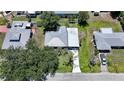 Aerial view of a well-maintained home with a metal roof, a long driveway, and green landscaping at 809 Kings Ct, Punta Gorda, FL 33950