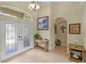 Foyer featuring tile flooring, console table, and an arched doorway at 13297 Flaherty Ave, Port Charlotte, FL 33981