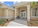Inviting front entrance featuring double doors, decorative columns, and stone landscaping at 13297 Flaherty Ave, Port Charlotte, FL 33981