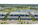 An aerial view of community, highlighting landscaping, lake, and building architecture at 14267 Heritage Landing Blvd # 1223, Punta Gorda, FL 33955