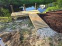 Wooden dock leading to tranquil waterside, enhancing outdoor enjoyment at 15431 Orangeade Dr, Punta Gorda, FL 33955