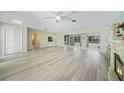 Spacious living area featuring sleek floors, a ceiling fan and a smooth transition to the outdoors at 16615 Acapulco Rd, Punta Gorda, FL 33955