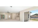 Bright living room with sliding glass doors, a ceiling fan, and views to the backyard at 19092 Woodbine Ave, Port Charlotte, FL 33954