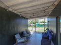 Cozy covered porch with decorative string lights and comfortable rocking chairs, perfect for outdoor relaxation at 2142 Gerard Ct, Port Charlotte, FL 33952