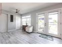 Bright living room with wood floors, light-colored walls, and a large glass door with a patio view at 21812 Edgewater Dr, Port Charlotte, FL 33952