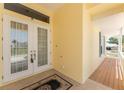 The inviting entrance features double doors, tile flooring, and a glimpse of the covered porch at 233 Beeney Se Rd, Port Charlotte, FL 33952