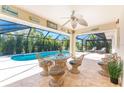 Beautiful screened lanai featuring stylish wicker seating and a view of the inviting pool at 279 Mariner Ln, Rotonda West, FL 33947