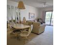 The living room features comfortable seating, a dining area, and a sliding door leading to a screened-in balcony at 4056 Oakview Dr # E10, Port Charlotte, FL 33980