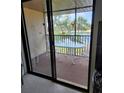 A cozy screened-in patio with a table and chairs overlooks a serene lake, inviting relaxation and outdoor enjoyment at 4056 Oakview Dr # E10, Port Charlotte, FL 33980