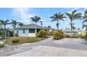 Single Gathering home with tropical landscaping, a front patio and concrete driveway at 4231 Hollis Ave, Port Charlotte, FL 33953