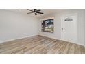 Bright living room with wood-look tile floors, a ceiling fan, and ample natural light at 4282 Pocatella Ave, North Port, FL 34287